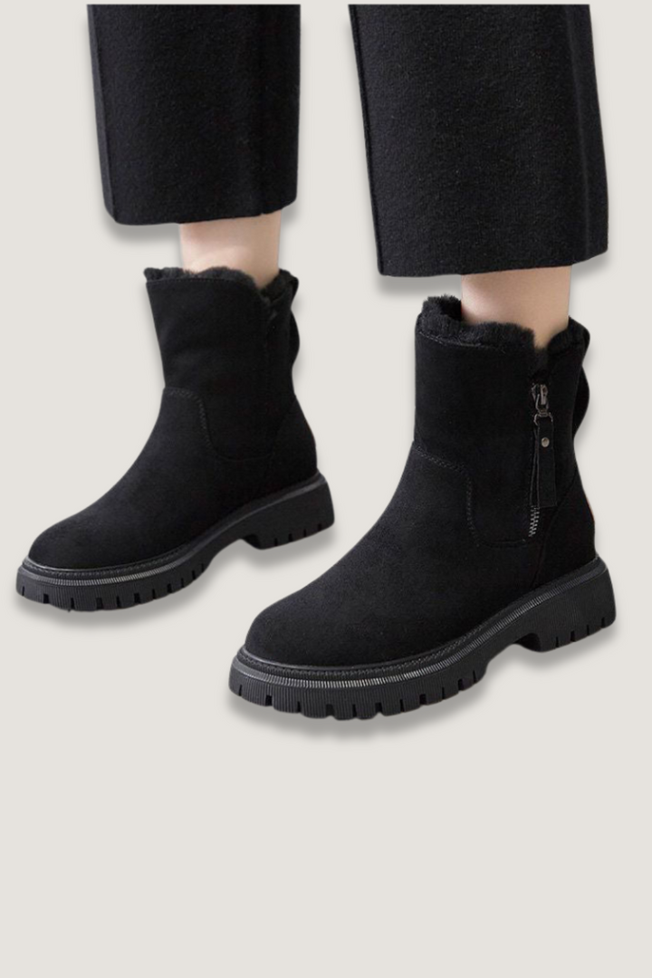 Women's black lined slip-on comfort boots, perfect for cozy winter everyday wear.