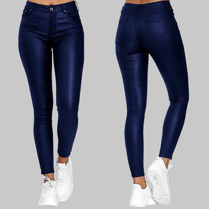 Unisex slim fit high-waisted pants with sleek finish & stretchy fabric. Versatile for casual or evening wear.