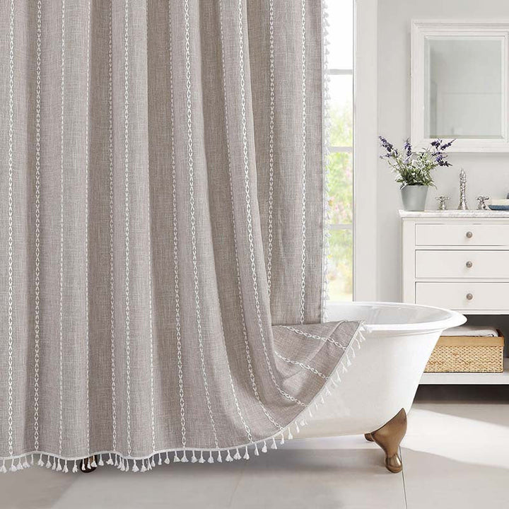"Bohemian farmhouse waterproof linen shower curtain with decorative tassels, shown in a warm beige plaid pattern."
