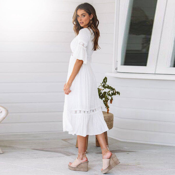 Boho white midi dress for women featuring a V-neck, flutter sleeves & tiered design. Ideal for summer and spring fashion.