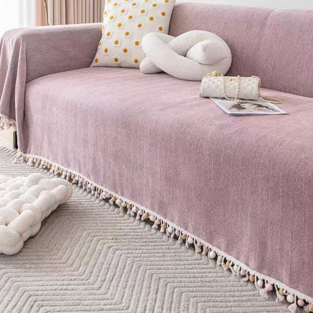 Boho style pet-friendly sofa cover with herringbone pattern and tassels, ideal for stylish protection in living rooms.