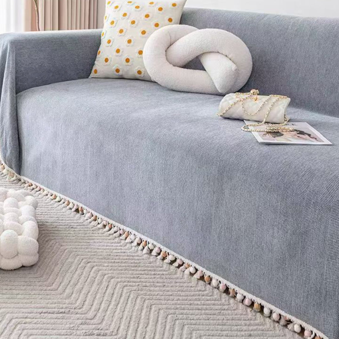 Boho style pet-friendly sofa cover with herringbone pattern and tassels, ideal for stylish protection in living rooms.