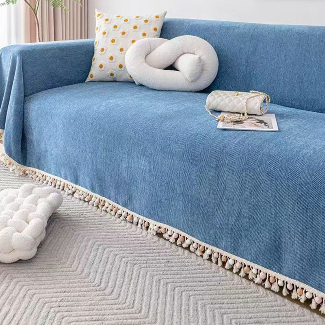 Boho style pet-friendly sofa cover with herringbone pattern and tassels, ideal for stylish protection in living rooms.