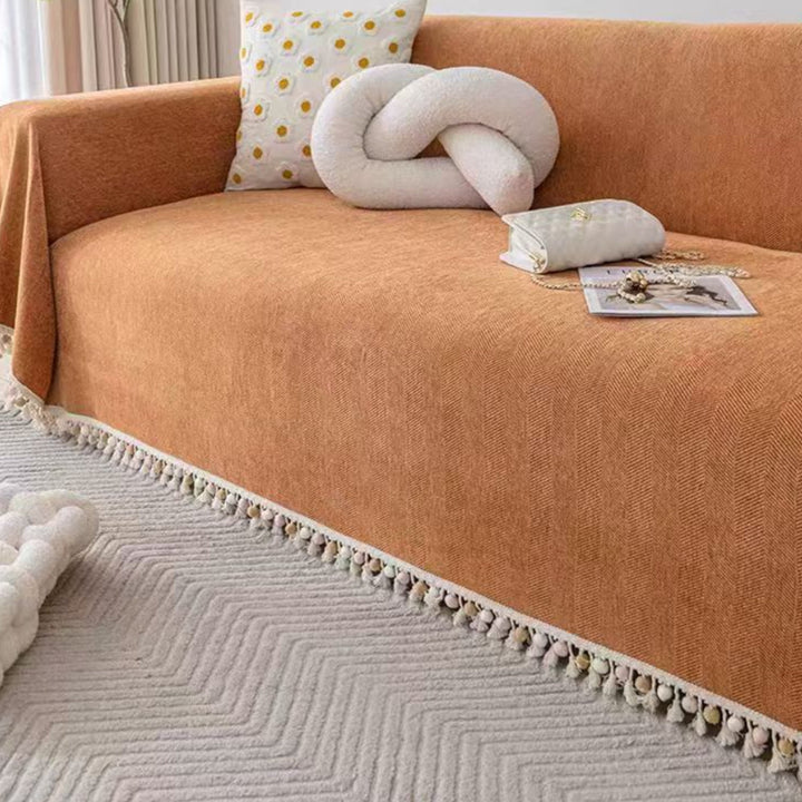 Boho style pet-friendly sofa cover with herringbone pattern and tassels, ideal for stylish protection in living rooms.