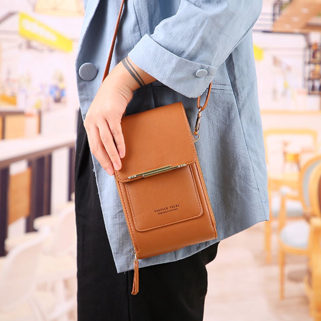 Stylish women's crossbody bag featuring a functional touchscreen window for smartphone use.