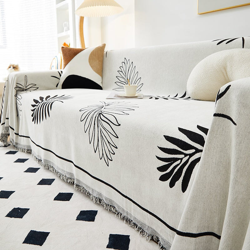 "Botanical sofa throw cover in stretchable protective fabric with elegant floral design fits snugly for modern home decor."