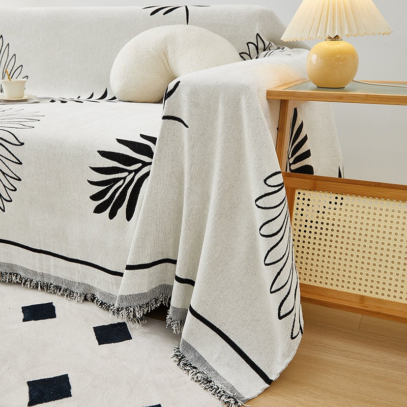 "Botanical sofa throw cover in stretchable protective fabric with elegant floral design fits snugly for modern home decor."