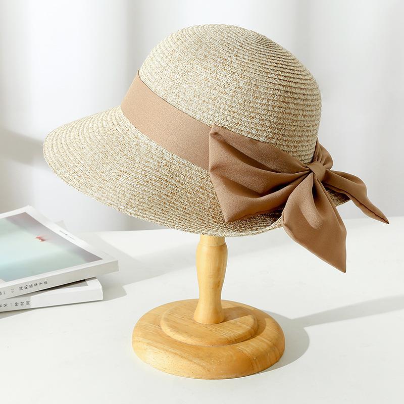 Elegant women's wide brim straw sun hat, combining fashion and essential sun protection for summer outings.