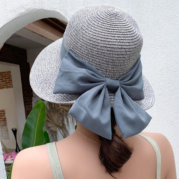 Chic wide brim straw beach hat for women, a versatile and stylish accessory for sunny days and travel.