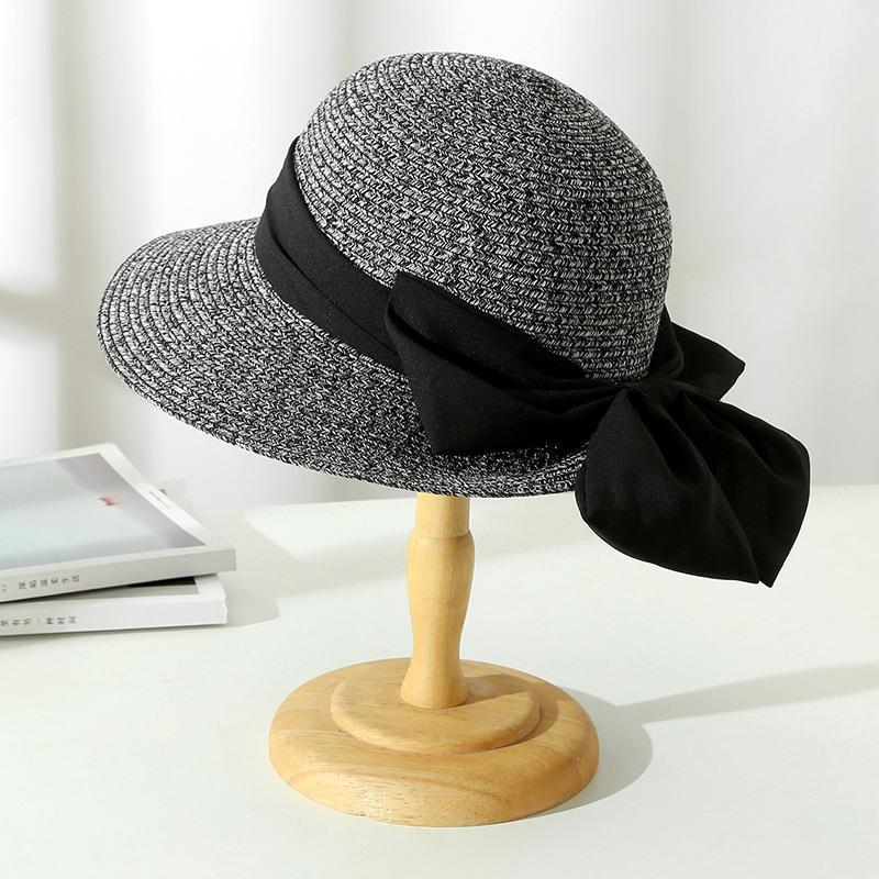 Women's summer straw hat with a wide brim, providing elegant and effective sun protection for any occasion.