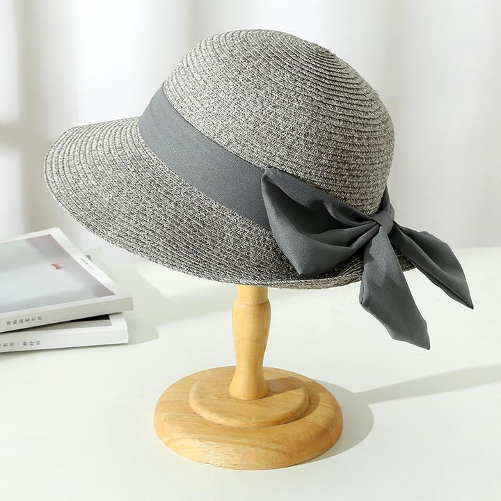 Close-up of a women's wide brim straw sun hat, showcasing its elegant weave and protective design.