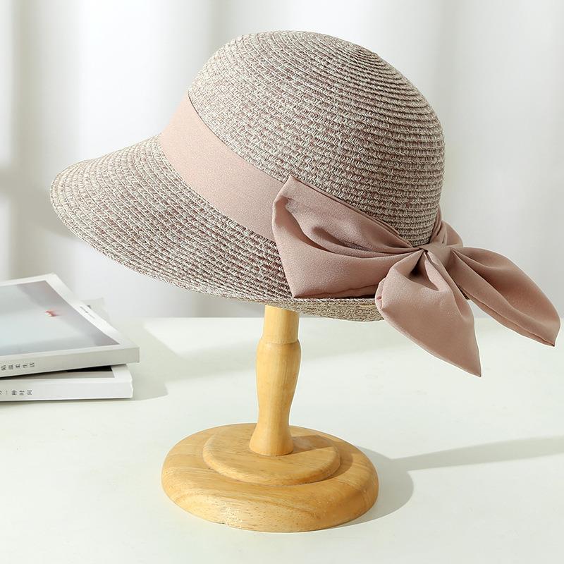 Women's stylish wide brim straw hat, ideal as a summer accessory for beach days and elegant sun protection.