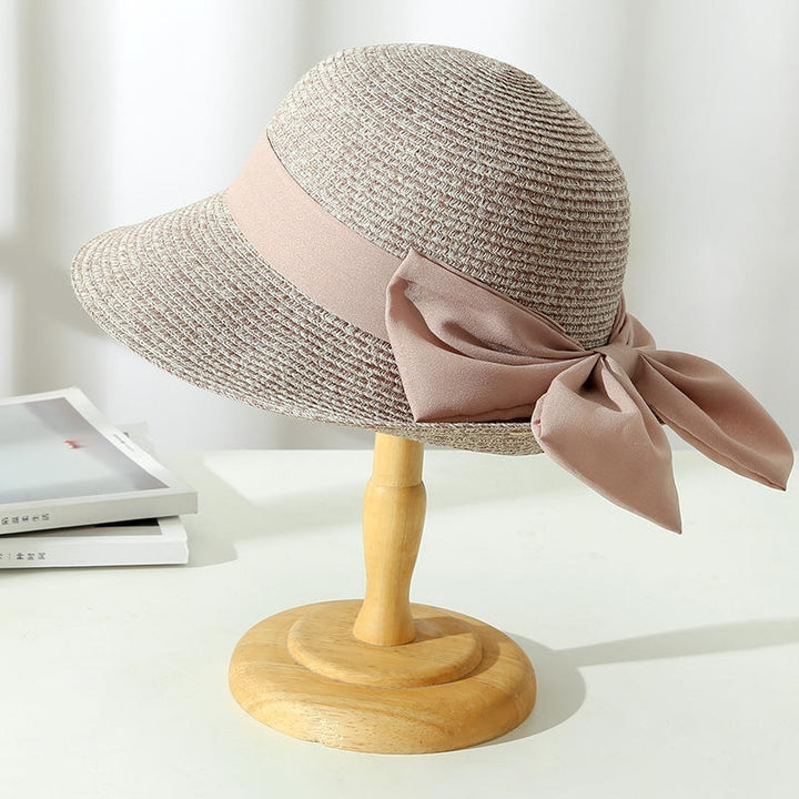 Women's stylish wide brim straw hat, ideal as a summer accessory for beach days and elegant sun protection.