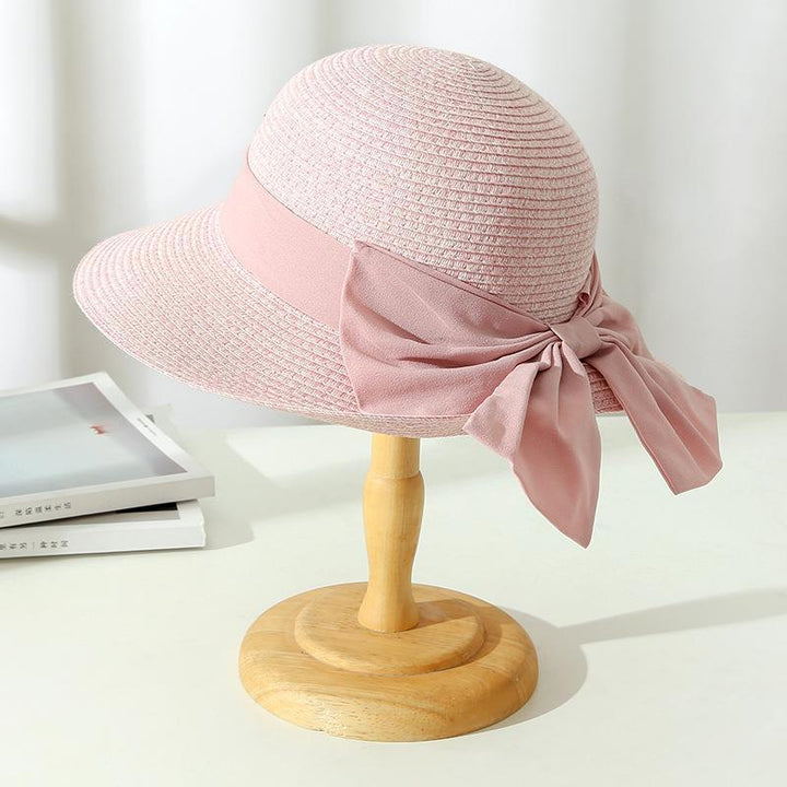 Fashionable straw sun hat for women with a wide brim, offering chic protection from the sun on vacation.