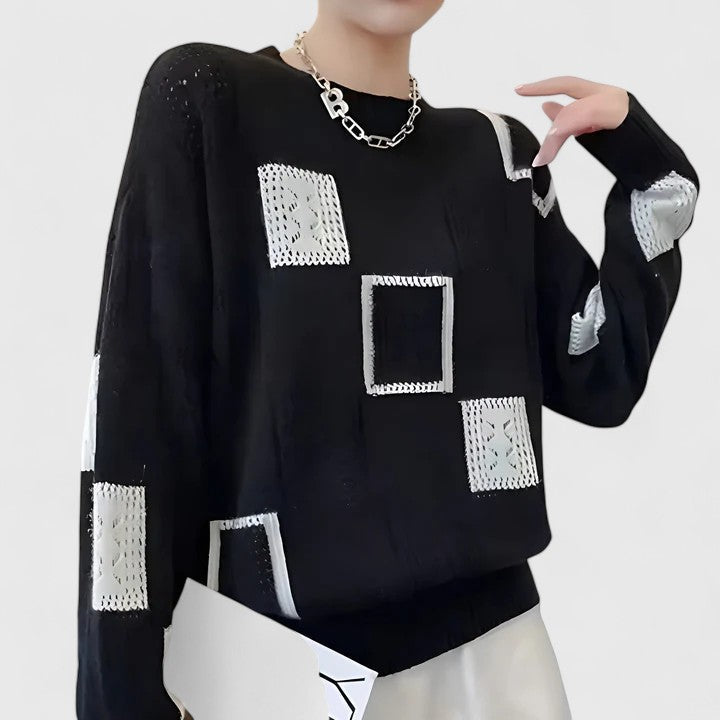 Close-up of elegant women's openwork knit sweater fabric, showing intricate detail. Cozy, chic round neck style.