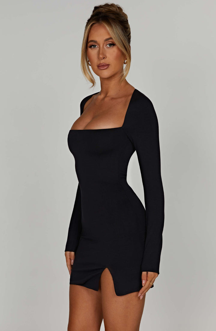 Fitted black mini dress for women, showcasing a sophisticated square neckline and long sleeves. Modern classic style.