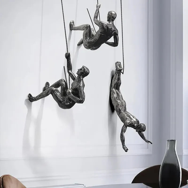 Abstract metallic climbing figures wall sculpture set, artistic wall decor.