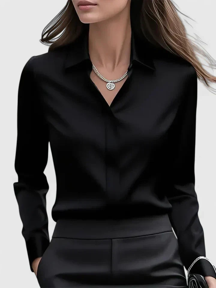 Modern classic women's button-down blouse. Elegant long sleeve top with curved hem for versatile styling.