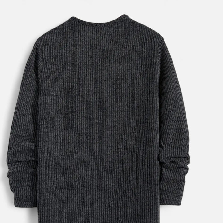 Detailed view of men's classic cable-knit henley. A cozy pullover essential for everyday style.
