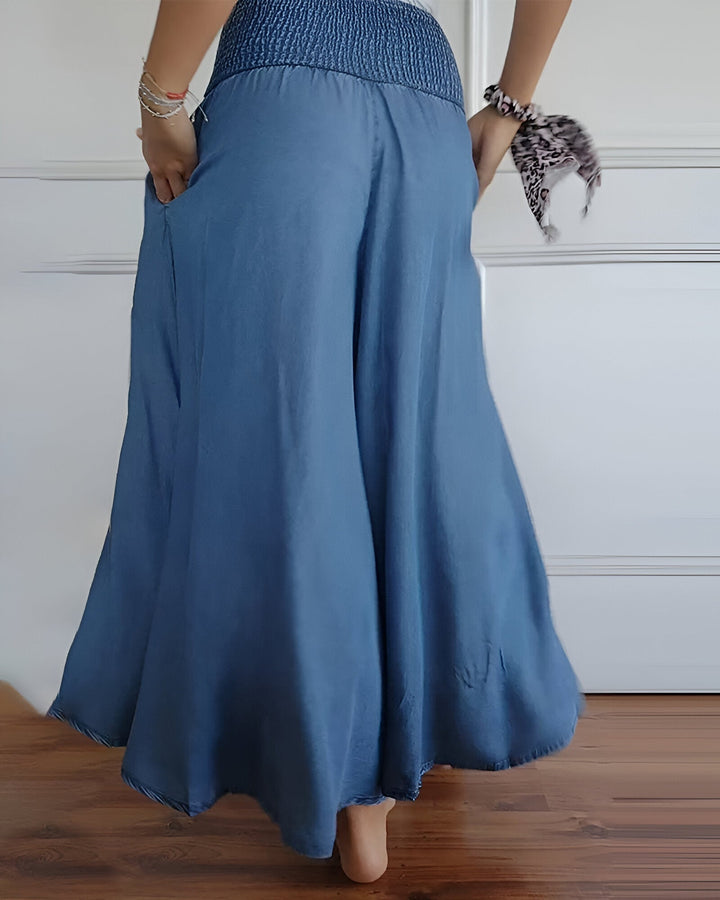 Casual women's smocked maxi skirt. Long, flowy design with side pockets for ultimate comfort & everyday wear.