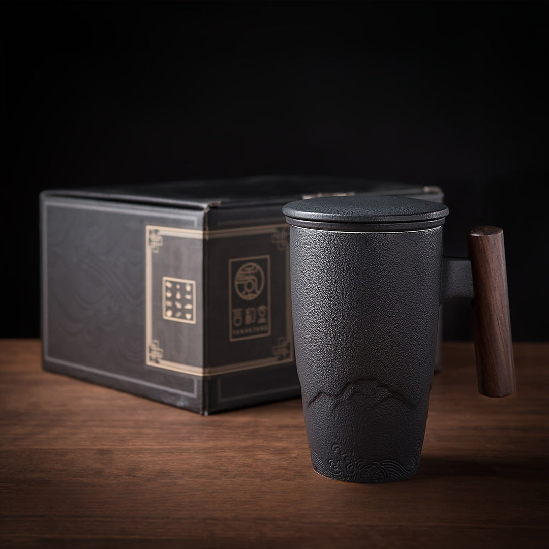 Comfortable handcrafted ceramic tea mug with built-in strainer; ergonomic, artistic design.