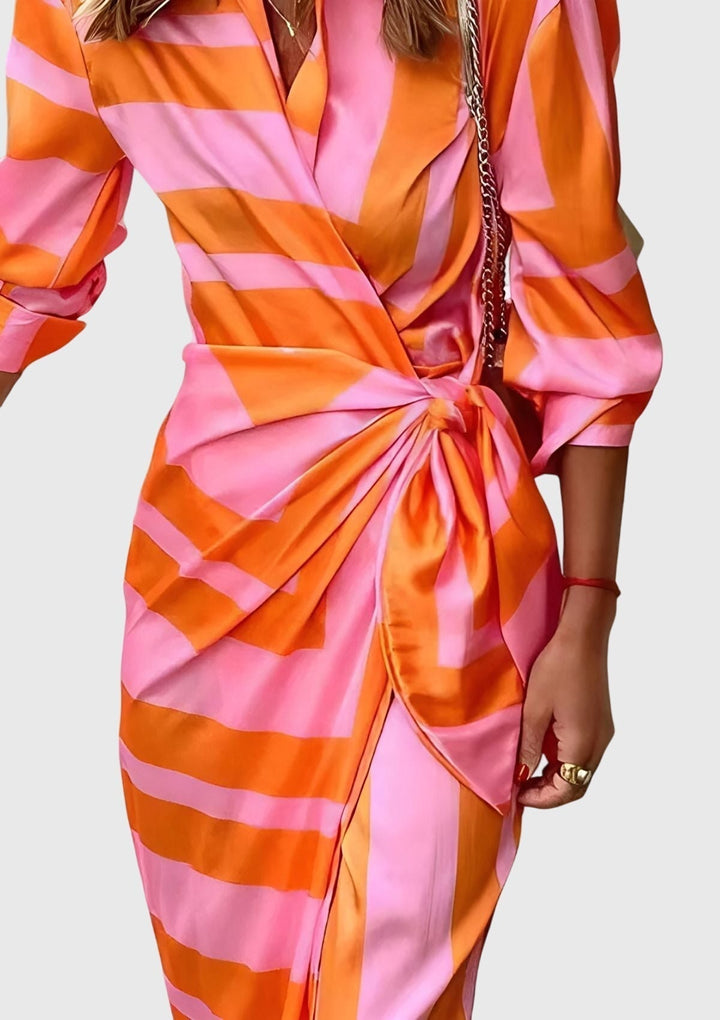 Detail of the flattering V-neck on a chic women's printed wrap dress, ideal for summer fashion.