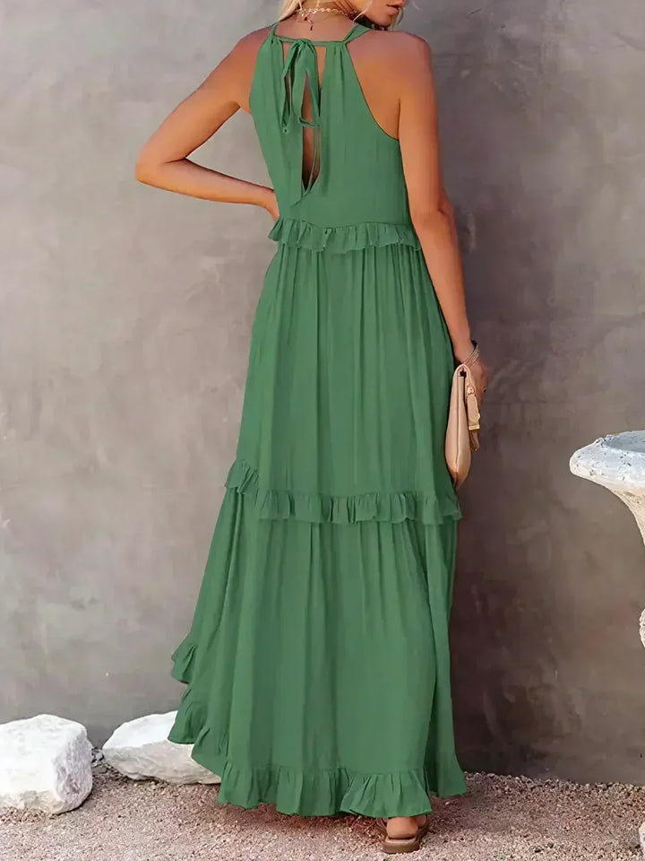 Chic floral print halterneck ruffle maxi dress with pockets, perfect for holidays.