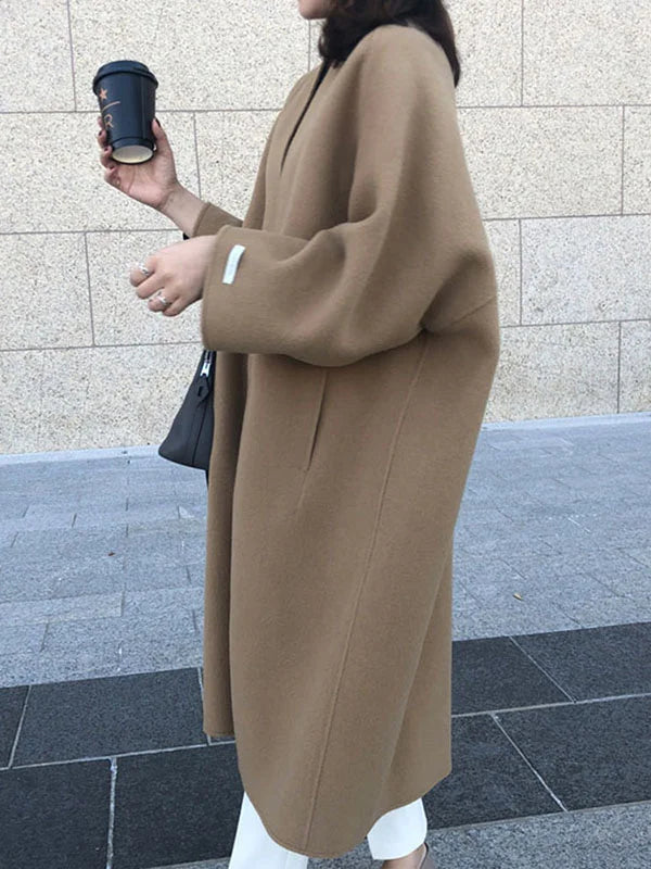Chic black long coat for women, ideal winter outerwear offering cozy warmth & a versatile look.