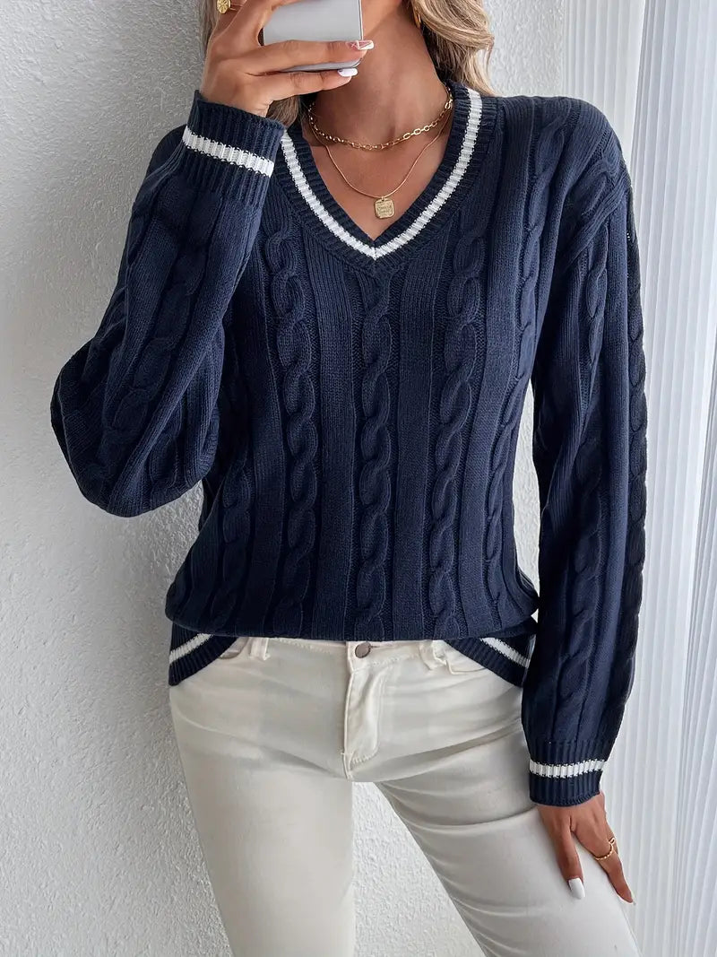 Chic women's navy V-neck cable knit sweater with long sleeves & striped trim. Perfect for winter fashion.