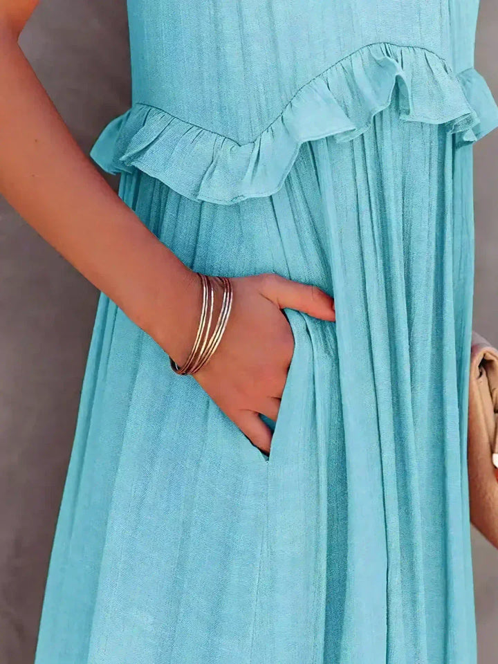 Sophisticated navy halterneck ruffle maxi dress with pockets, holiday-ready style.