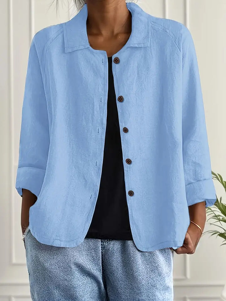 Classic women's collared button-down blouse with three-quarter sleeves for versatile wear.
