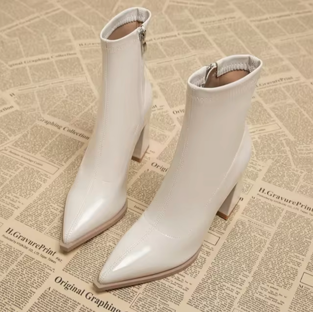 Women's chic pointed toe ankle boots with a stylish block heel and convenient zipper. Elegant & versatile fashion footwear.