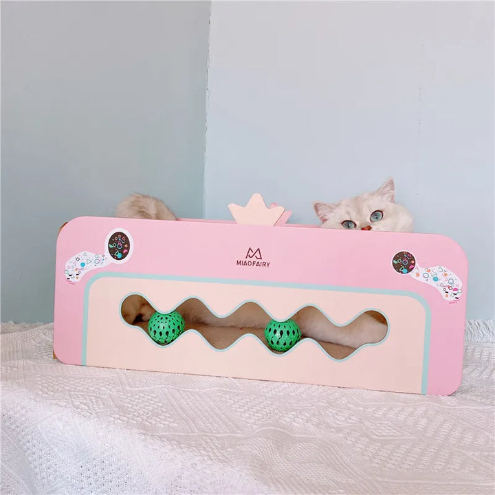 Stylish pink feline furniture: a cat scratcher box with an integrated toy, perfect for kitten play and scratching.