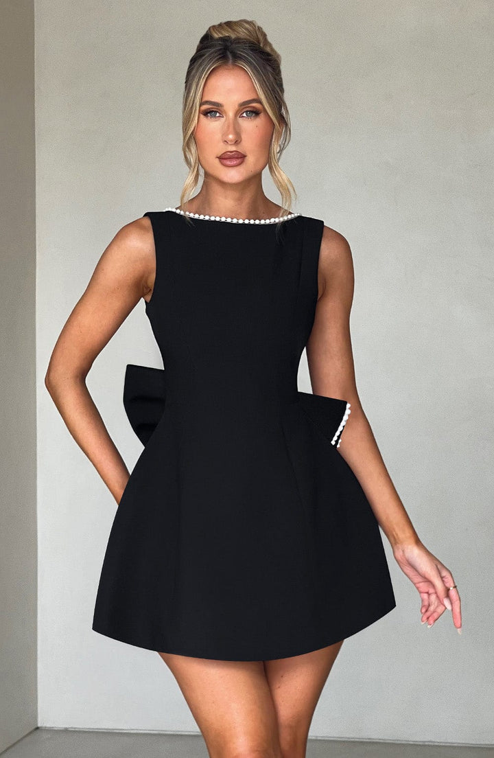 Versatile women's sleeveless mini dress with a charming pearl neckline for events.