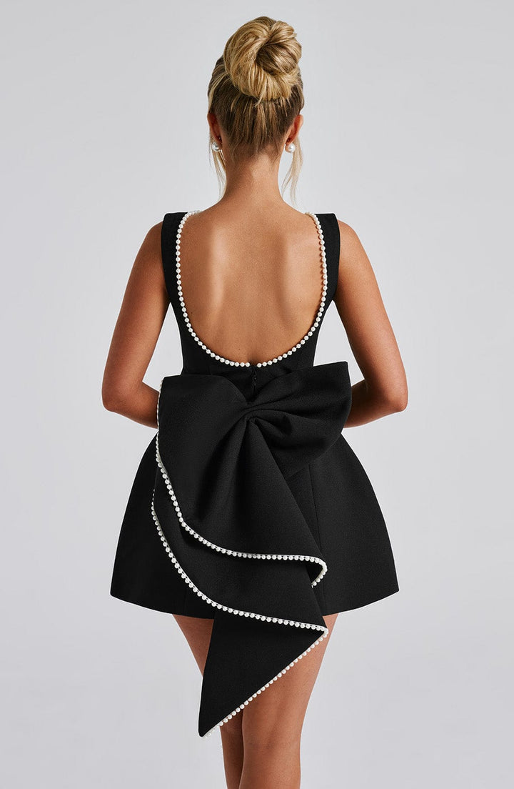 Cocktail-ready women's mini dress, sleeveless, featuring a luxurious pearl neckline.