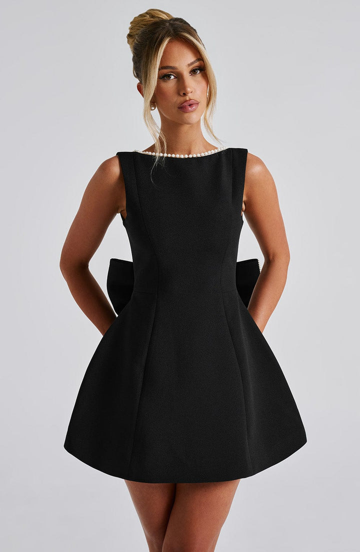 Beautiful women's mini dress, sleeveless, with a sophisticated pearl-adorned neckline.