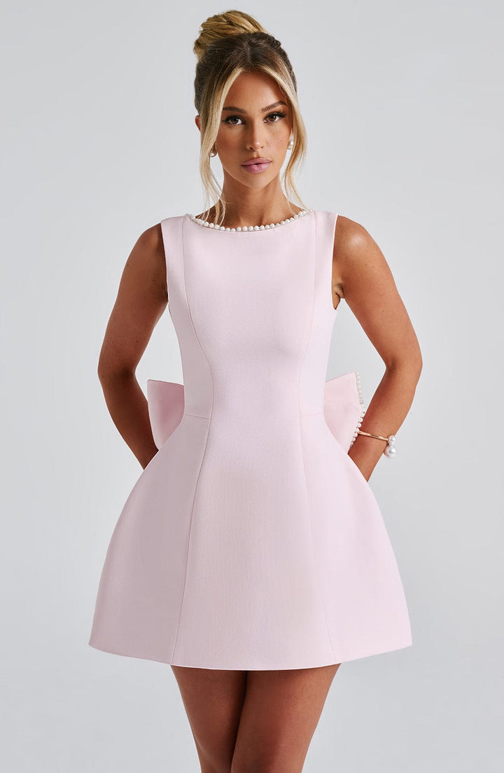 Women's sleeveless mini dress with elegant pearl neckline for parties.