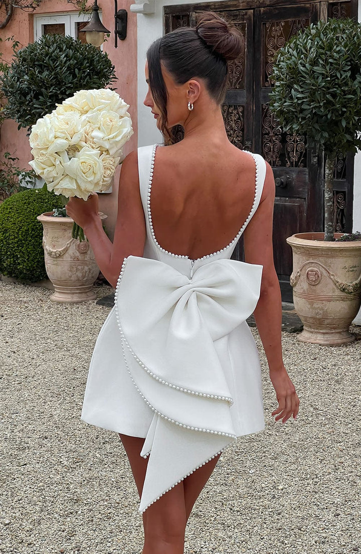 A stylish women's mini dress, sleeveless, with an eye-catching pearl neckline.
