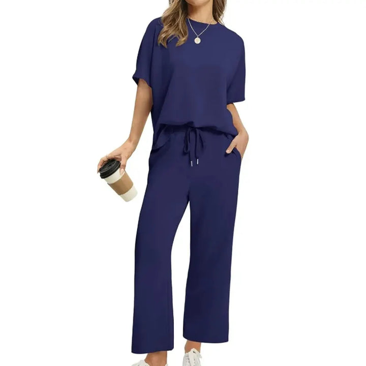 Versatile women's ribbed travel outfit set. Includes a comfy half-sleeve top & relaxed ankle trousers for stylish casual wear.