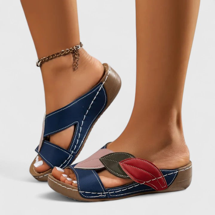 Side view of a women's comfort sandal with adjustable straps & orthopedic arch support technology.