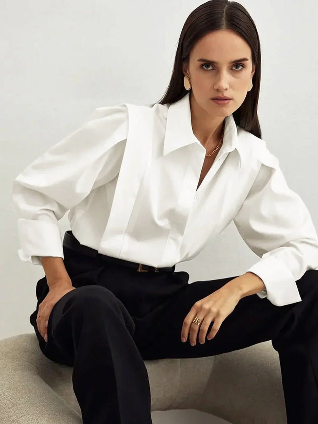 Stylish women's button-down blouse with a relaxed boxy fit, great for modern versatile outfits.