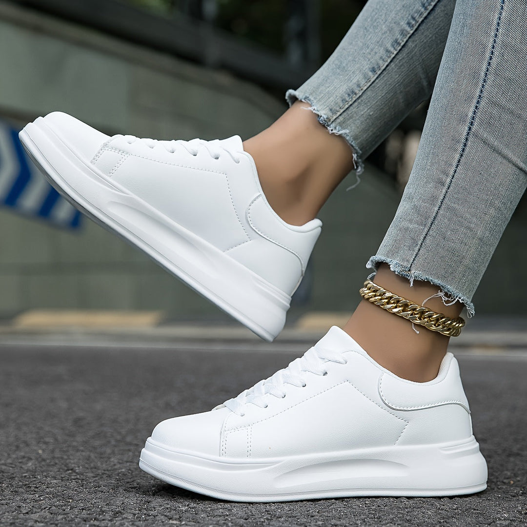 Trendy white low-top women's sneakers, a must-have for modern, minimalist fashion.
