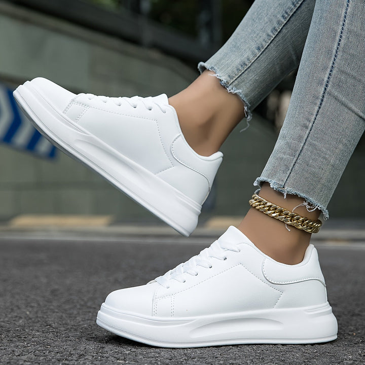 Trendy white low-top women's sneakers, a must-have for modern, minimalist fashion.