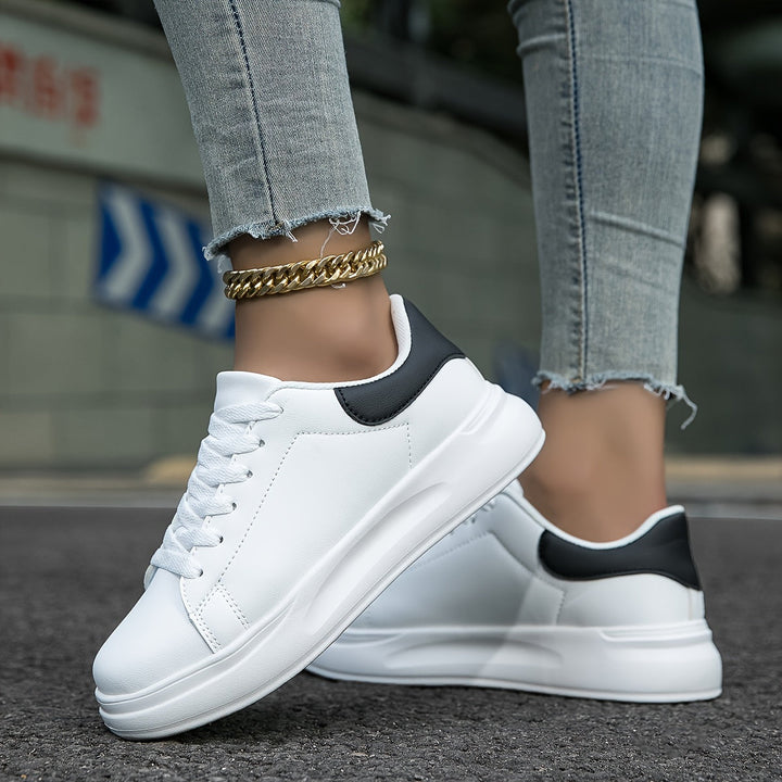 Comfortable women's white low-top sneakers, ideal for casual everyday wear.