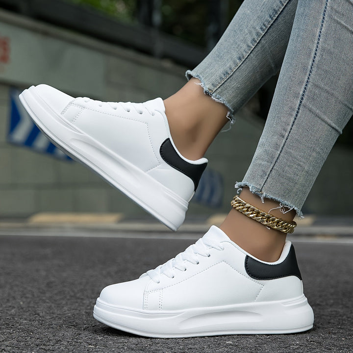 Modern minimalist white low-top sneakers, a chic fashion statement for women.