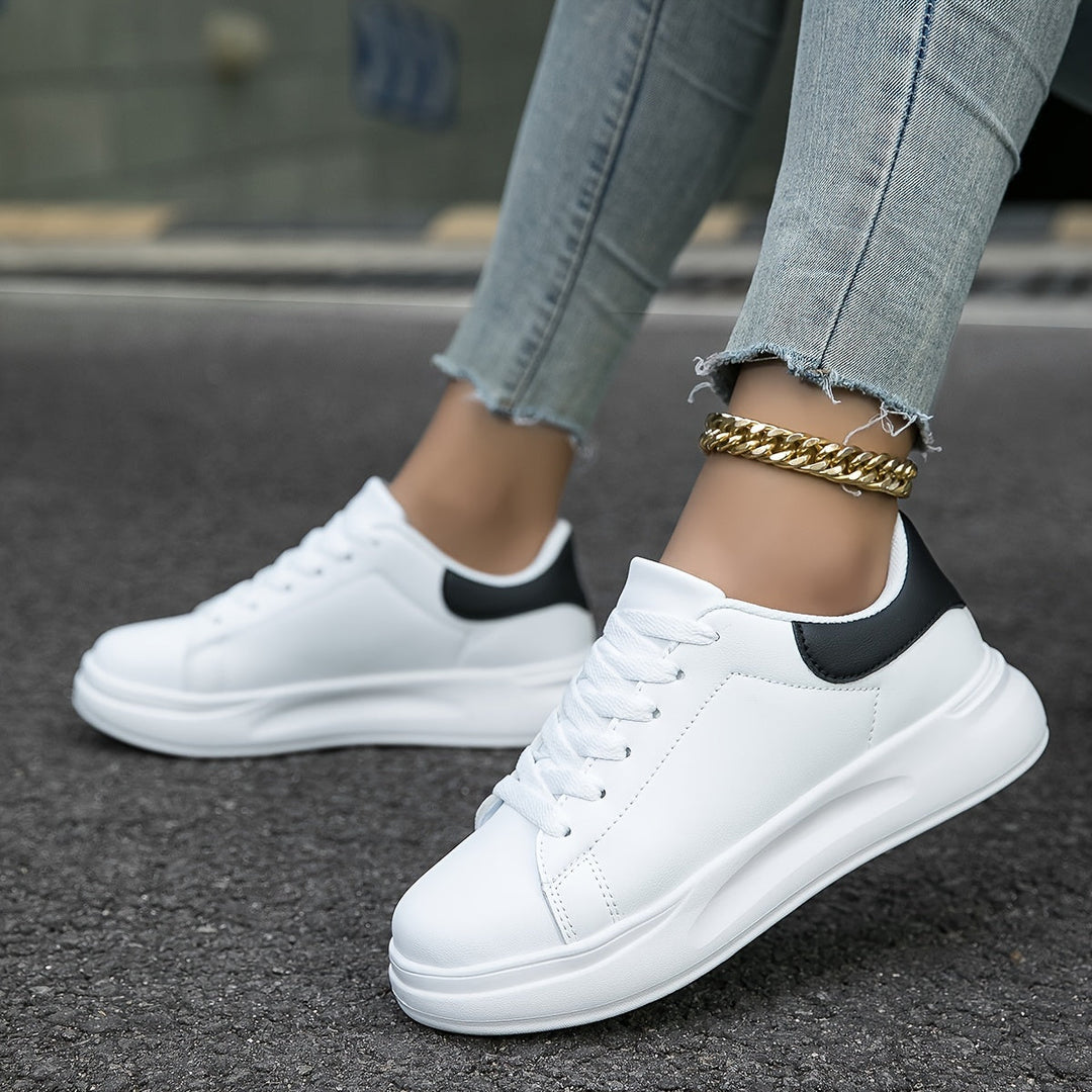 Versatile white low-top women's sneakers, offering chic style for any casual outfit.