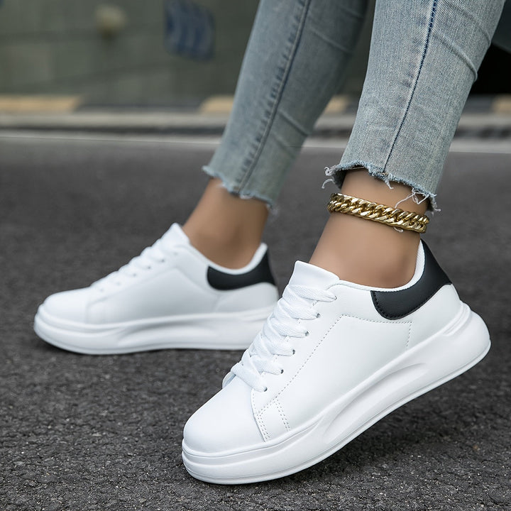 Versatile white low-top women's sneakers, offering chic style for any casual outfit.