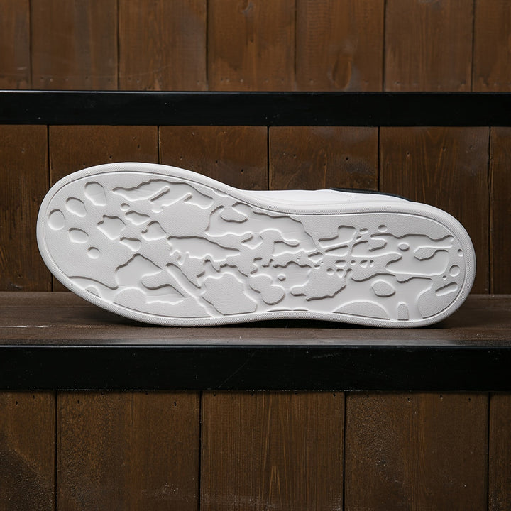 New women's fashion sneakers: chic white low-tops with a modern minimalist design.