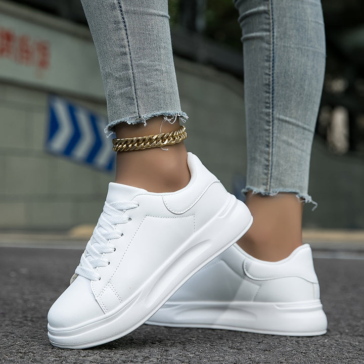 Classic white low-top women's footwear, essential for comfortable everyday style.