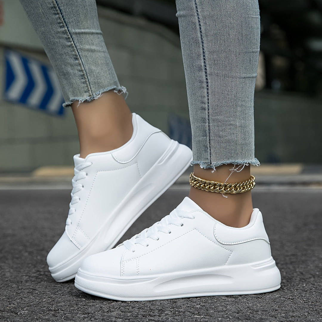 Elegant white low-top women's sneakers, blending chic fashion with everyday comfort.